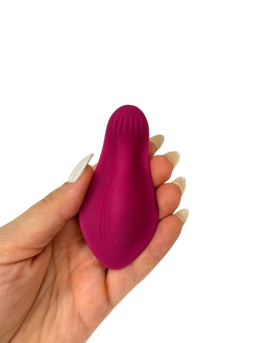 Compact wearable vibrator with curved ergonomic design for comfort.