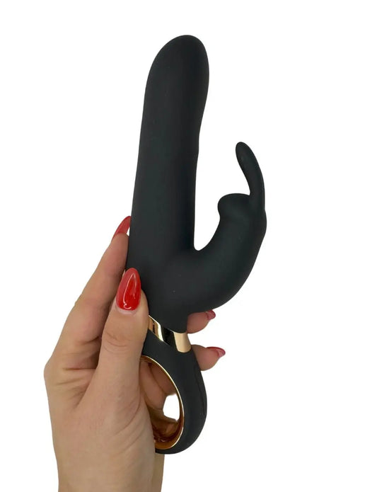 Holding the Multi-Speed Rotating Rabbit Vibrator by Secret Kiss, showcasing its ergonomic handle and dual-stimulation design.